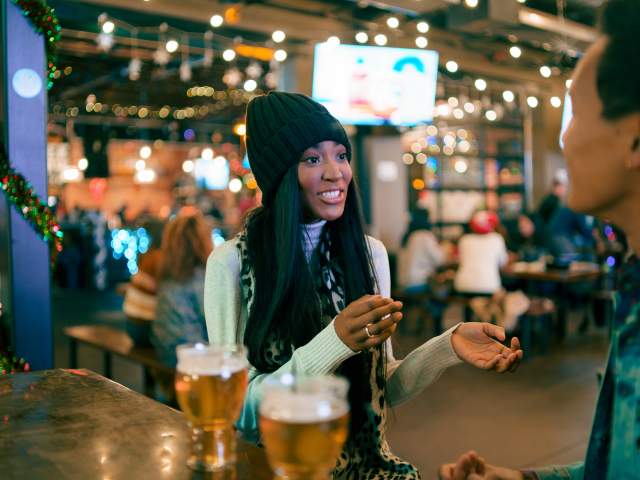People enjoy the sights, sounds, tastes, and aromas at a downtown brewery with friends.