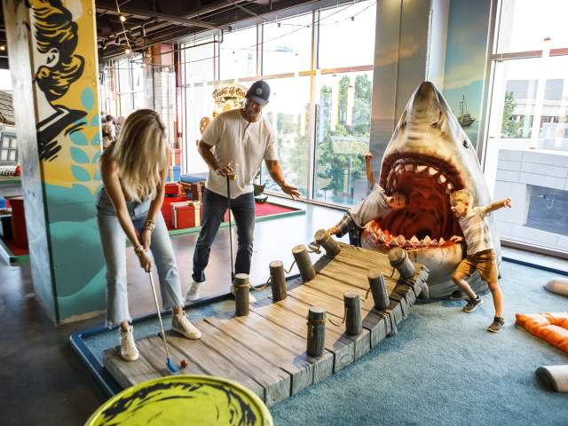 Group Therapy is a pub and playground offering experiential entertainment and the first and only indoor venue to offer a cocktail bar with a full food menu, an 18 hole wacky mini golf course, ice curling, ping pong, axe throwing, and tons of backyard games.