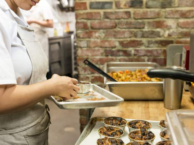 Woker prepping food at The Anchorage