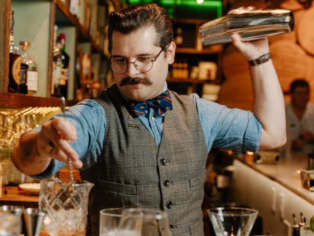 Colin, the bartender at The Rabbit Hole in the Village of West Greenville, SC, mixes up cocktails.