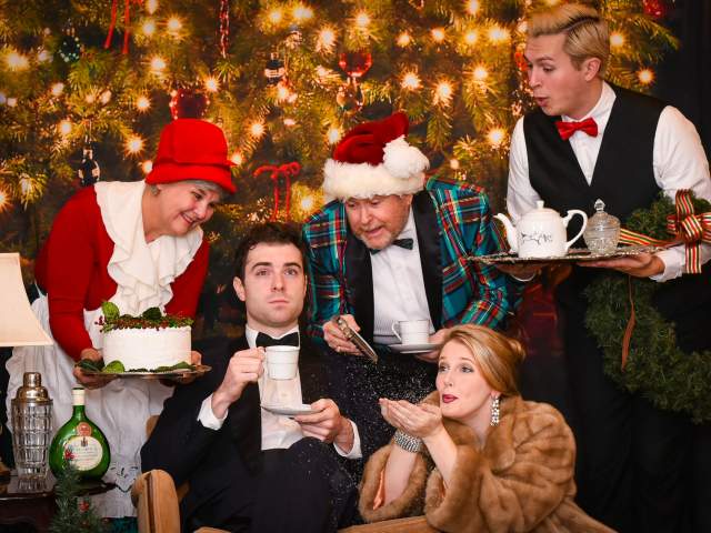 Actors act silly in Christmas attire in front of a Christmas tree at Centre Stage in downtown Greenville, SC.