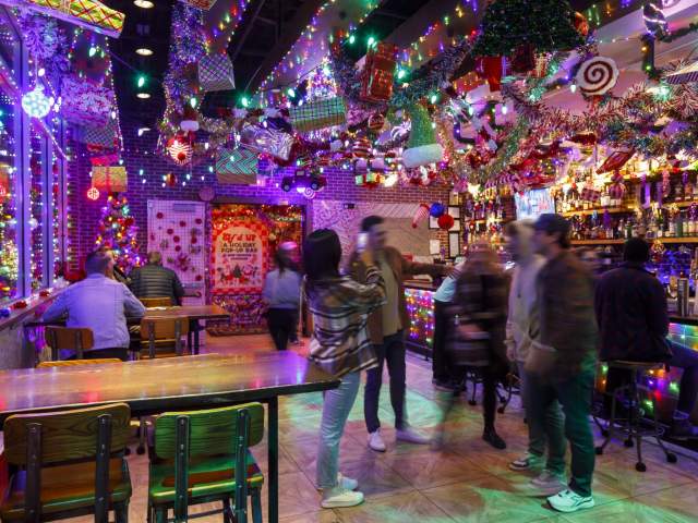 Patrons hang out at Elf'd Up, a Christmas display at bar/restaurant UP on the Roof in downtown Greenville, SC.