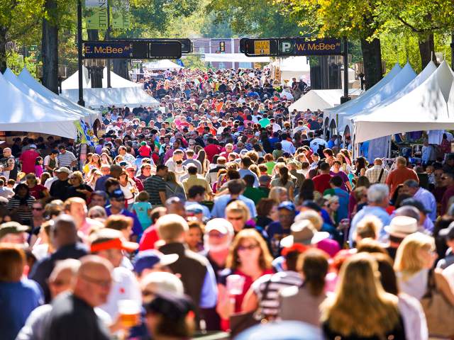 Large gathering of vendors and customers on the streets of Greenville during the Fall for Greenville event.