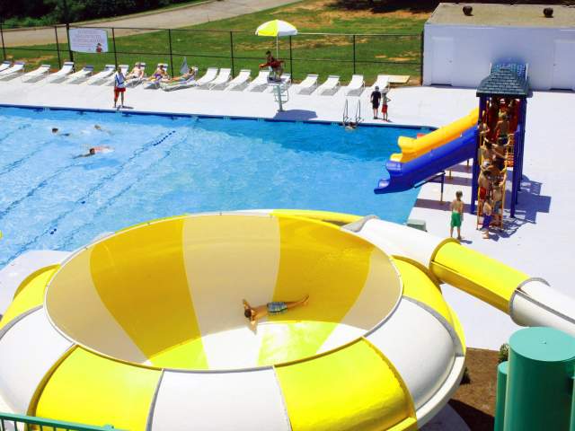 A child goes down the yellow-and-white-striped funnel slide at 7th Inning Splash Waterpark in Piedmont, SC.