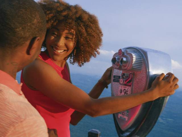 People looking through a tower viewer at Caesar's Head