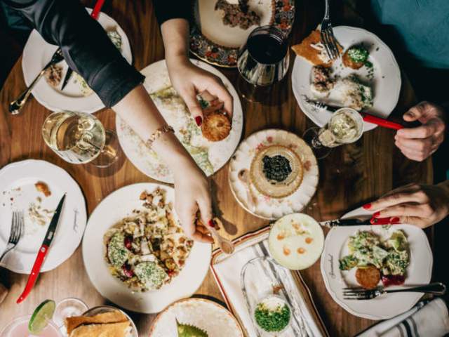 Scoundrel Restaurant food spread with people dining