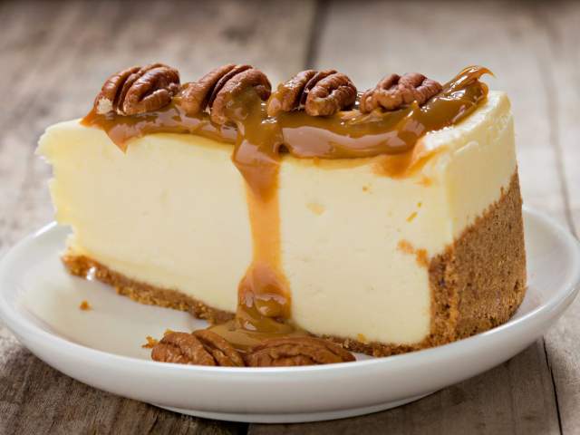 A slice of cheesecake covered in caramel and pecans from Stax Bakery in Greenville, SC.