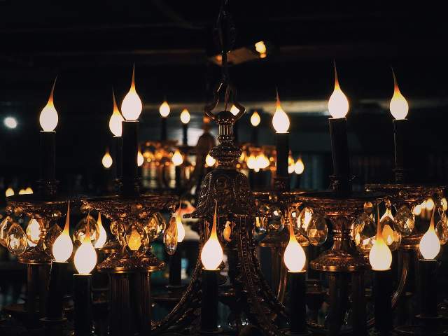 A unique and eclectic light fixture with 1920s vibes hangs above The Library at The Rabbit Hole in the Village of West Greenville, SC.