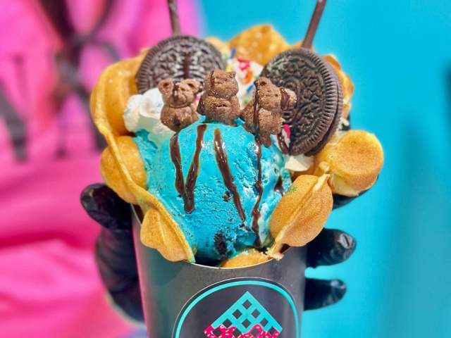 A bubble waffles covered in electric blue ice cream with Oreos on top from Waffle Drop in Greenville, SC.