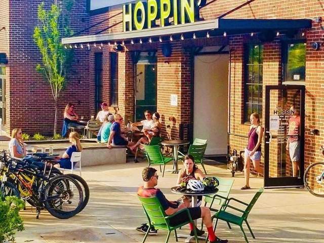Patrons enjoy the outdoors near the entrance to Hoppin' GVL in downtown Greenville, SC.