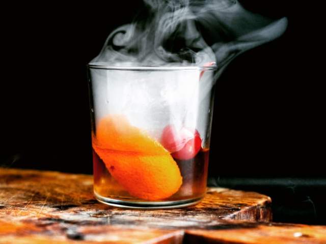 A cocktail smokes at Neat Bourbon Bar in downtown Greenville, SC.