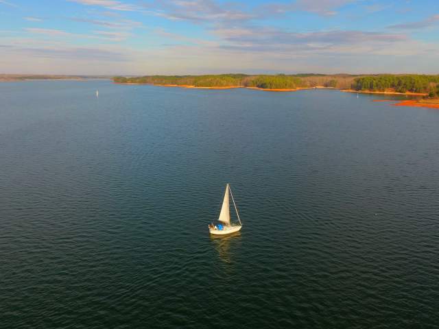 A lone sailboat sits amid the vast Lake Hartwell in South Carolina.