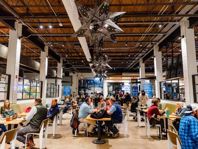 Lots of people sitting at tables of Southernside Brewing