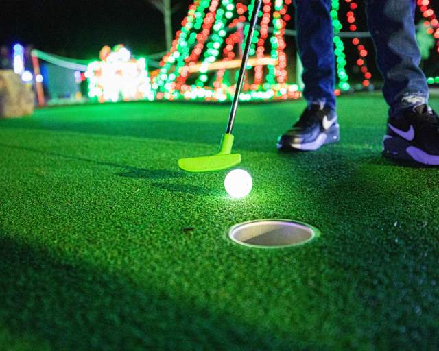 A glow-in-the-dark golf ball at Takeoff Mini Golf's annual Christmas Golf event.