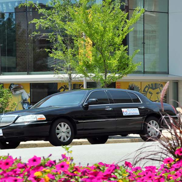 Private transportation service making a stop in front of a building.