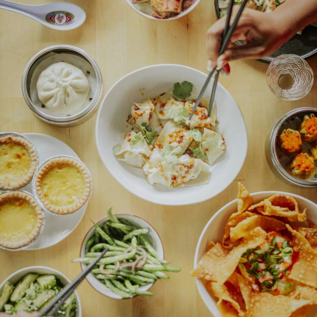 Multiple plates of food at Sum Bar