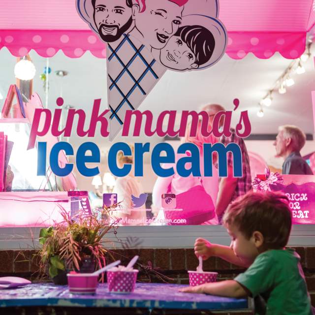 A little boy eats ice cream outside in the evening at Pink Mama's Ice Cream in Travelers Rest, SC.
