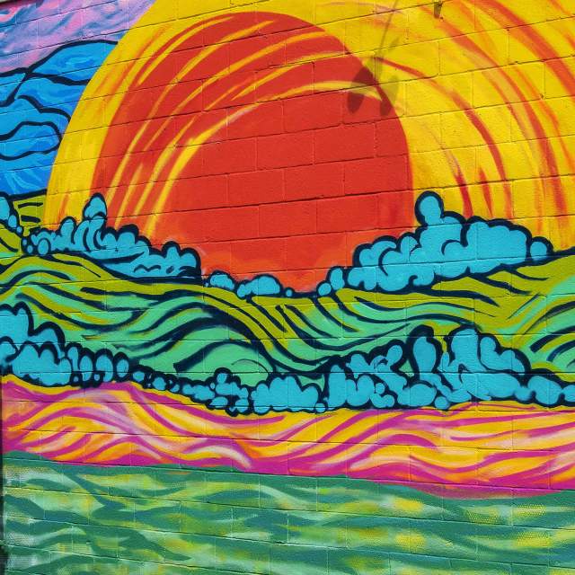 A sunny mural located on the side of the Coastal Crust in downtown Travelers Rest, SC.