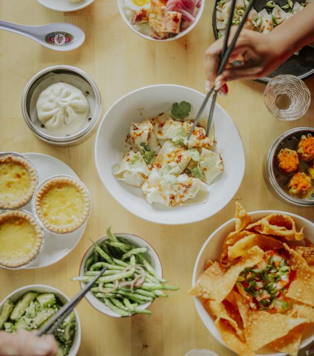 Multiple plates of food at Sum Bar