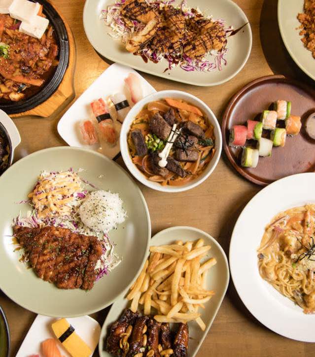Table full of food and dishes prepared at Otto Izakaya Downtown