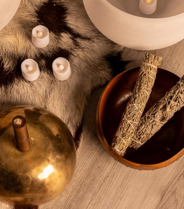 Raven and Moon Sound Bath Experience with sage in a bowl and candles laying around