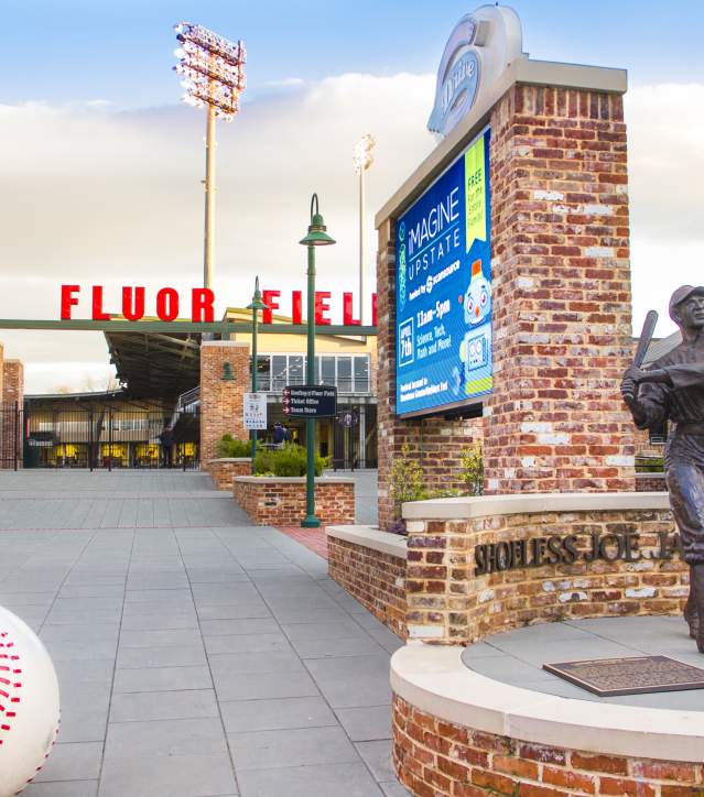 The Shoeless Joe Jackson statue, depicting the baseball legend holding a bat, located in front of Fluor Field, home of the Greenville Drive.