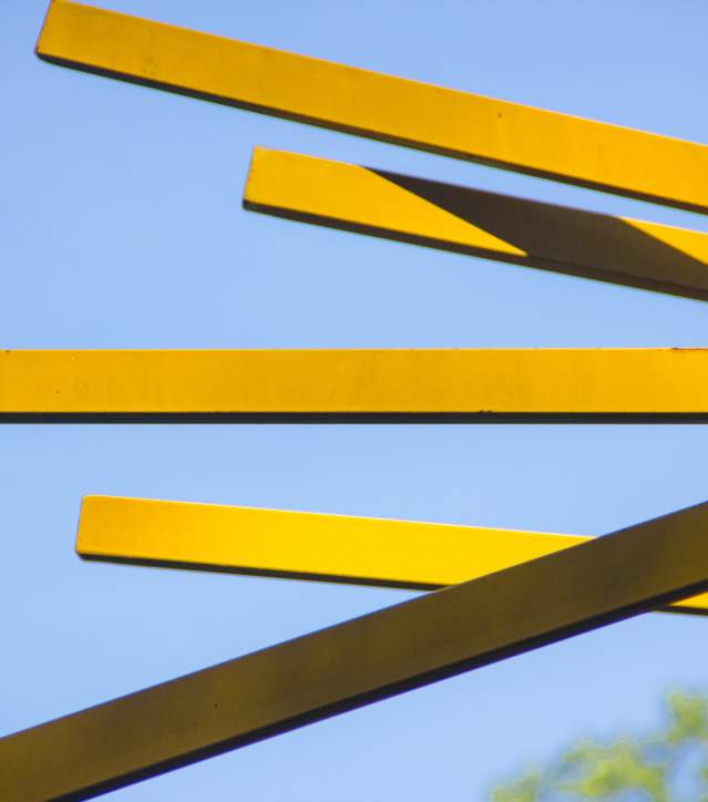 A bright yellow overhead structure designed by Clemson architecture students and neighborhood children, showcasing community collaboration and creativity.