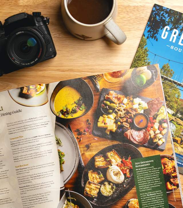 The 2025 Destination Guide splays open to an article on Downtown Dining in Greenville, SC.