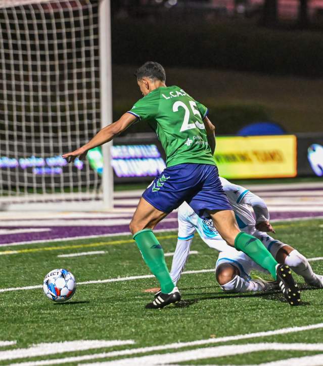 Greenville Triumph soccer Player #25 making a goal