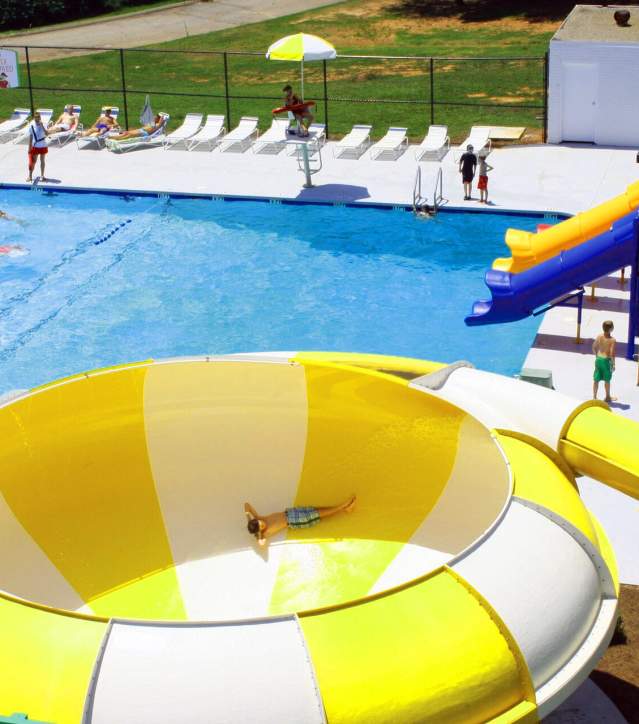 A child goes down the yellow-and-white-striped funnel slide at 7th Inning Splash Waterpark in Piedmont, SC.