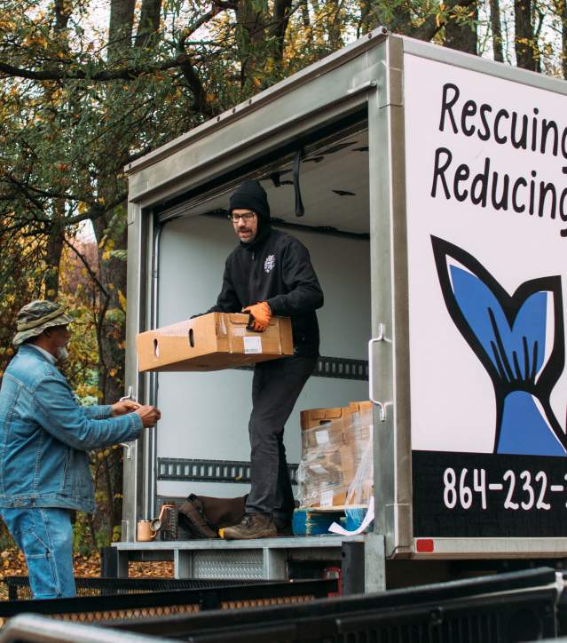 Volunteers unloading food donations