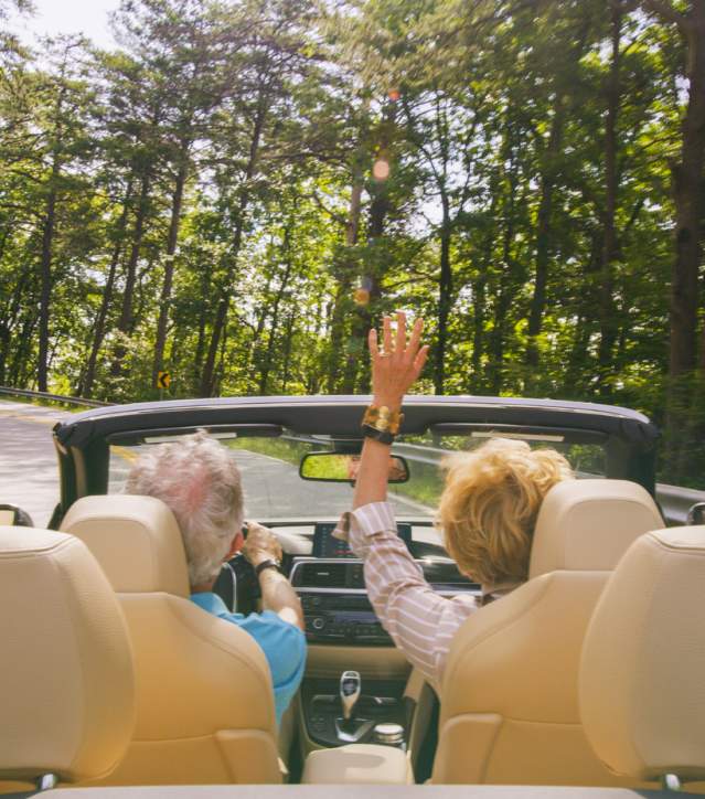 Couple Driving Convertible up to Caesars Head