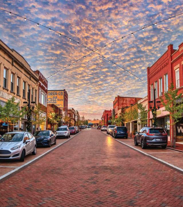 Trade Street in downtown Greer, SC looks idyllic with strung lights and old-timey shops and buildings.