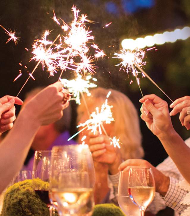 People holding sparklers while attending a party at a Cliffs Community.