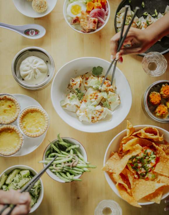 Multiple plates of food at Sum Bar