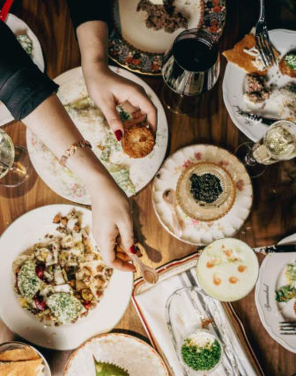 Scoundrel Restaurant food spread with people dining