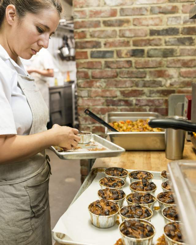Woker prepping food at The Anchorage