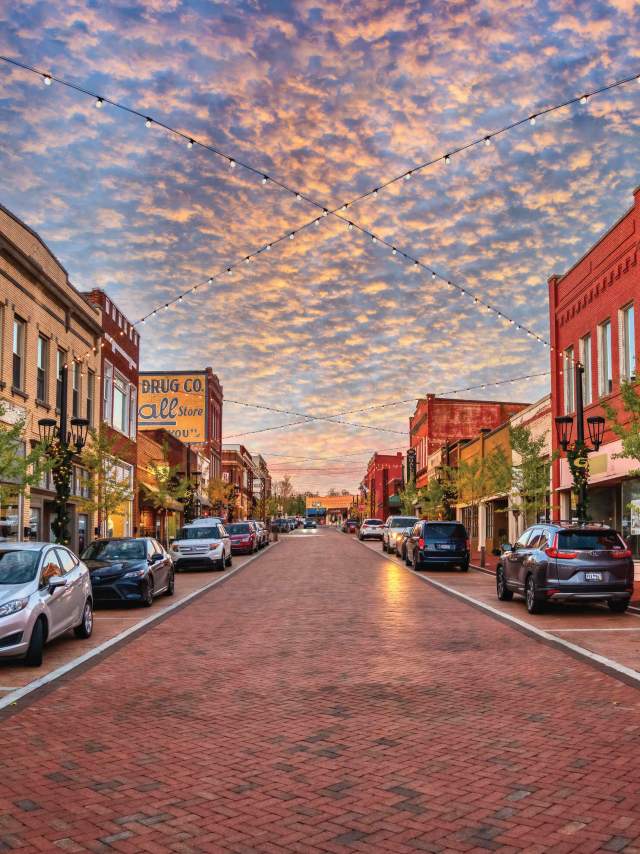 Trade Street in downtown Greer, SC looks idyllic with strung lights and old-timey shops and buildings.