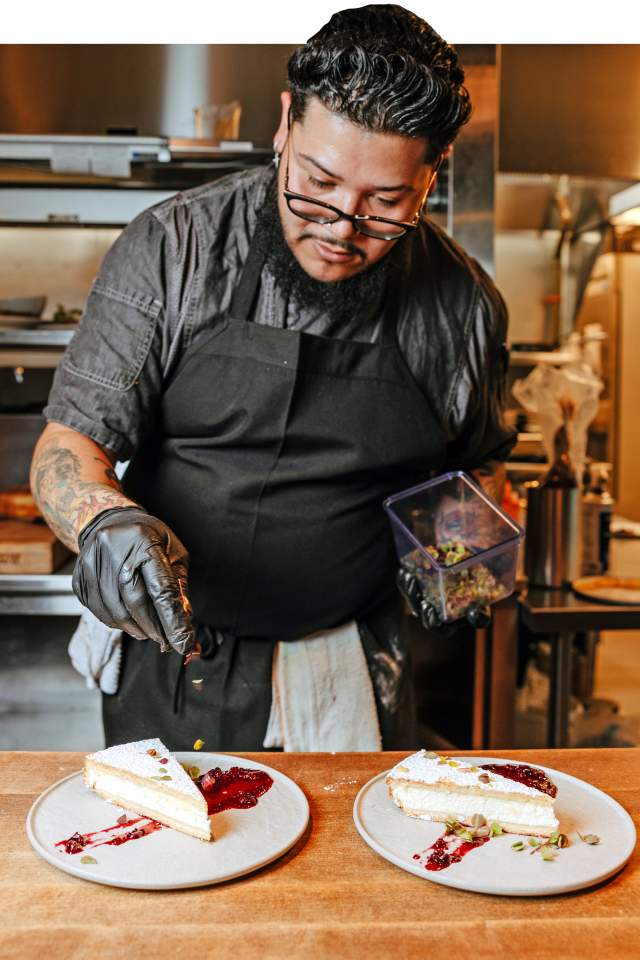 A chef plates dessert in the kitchen at a euphoria event in Greenville, SC.