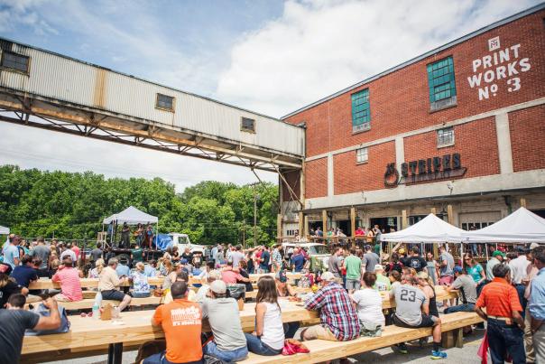 A crowd enjoys a festival at Taylors Mill, just outside the doors of 13 Stripes Brewery in Taylors, SC.