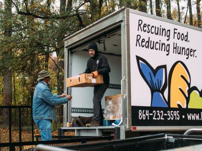Volunteers unloading food donations