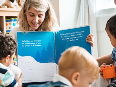 Volunteer reads book to children