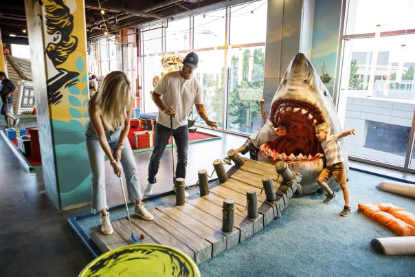 Group Therapy is a pub and playground offering experiential entertainment and the first and only indoor venue to offer a cocktail bar with a full food menu, an 18 hole wacky mini golf course, ice curling, ping pong, axe throwing, and tons of backyard games.