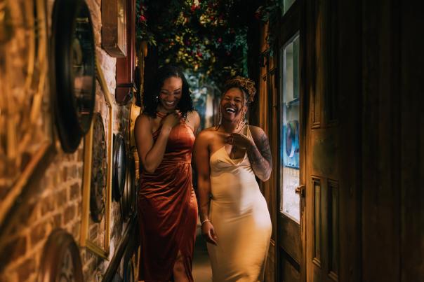 Two girls walk down the hall full of clocks at the Alice in Wonderland-themed Rabbit Hole cocktail bar in downtown Greenville, SC.