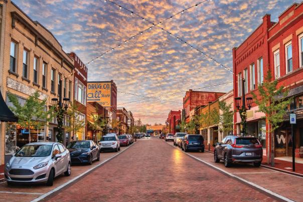 Trade Street in downtown Greer, SC looks idyllic with strung lights and old-timey shops and buildings.