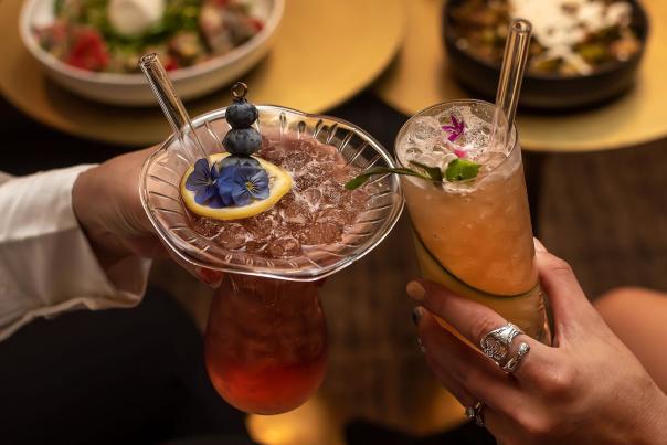 A toast is made with two fruity cocktails from The Press Room speakeasy in downtown Greenville, SC.