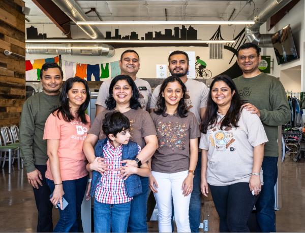 Desai family posing in Green Laundry Lounge. Green Laundry Lounge vision is to reinvent laundromat & dry-cleaning system so community can take advantage to laundry services easily and spend quality family time in-store, from their lounge area and cafe, or at-home by having pickup/drop-off service.  Their goal is to use most energy efficient washers, dryers, sustainable and ecofriendly laundry products.
