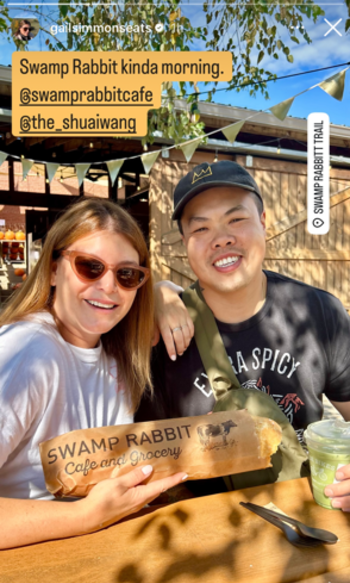 "Top Chef" judge, Gail Simmons holding a loaf of Stecca bread, and former "Top Chef" contestant, Shuai Wang, at Swamp Rabbit Cafe and Grocery