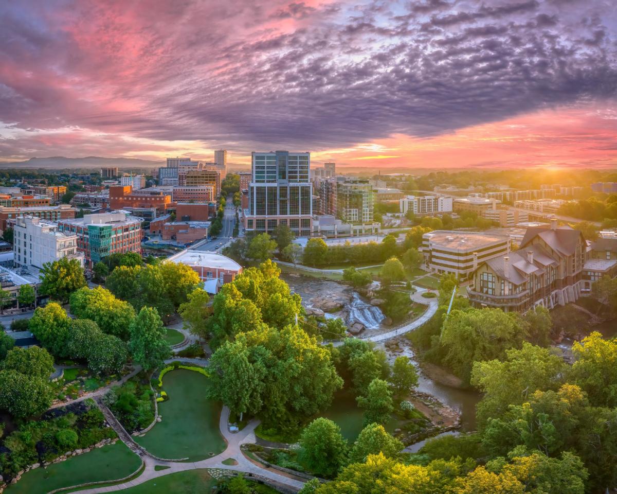 The sun shines in beautiful pink and purple hues above downtown Greenville, SC.