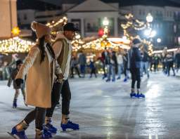 Visitors skating on the Ice at Carter Green at the Carmel Christkindlmarkt German market at night.